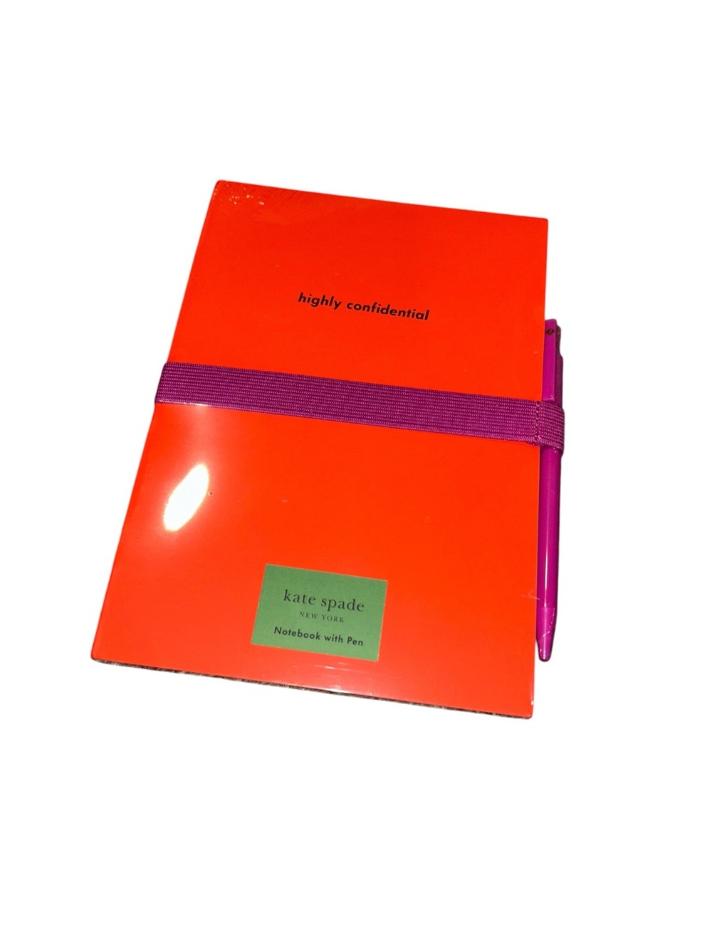 kate spade orange notebook with purple elastic and pink pen